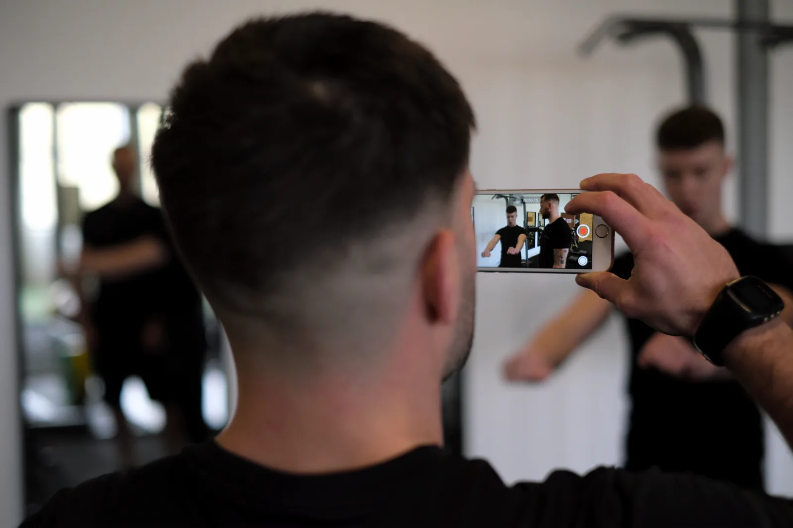 A learner recording a training session on a phone