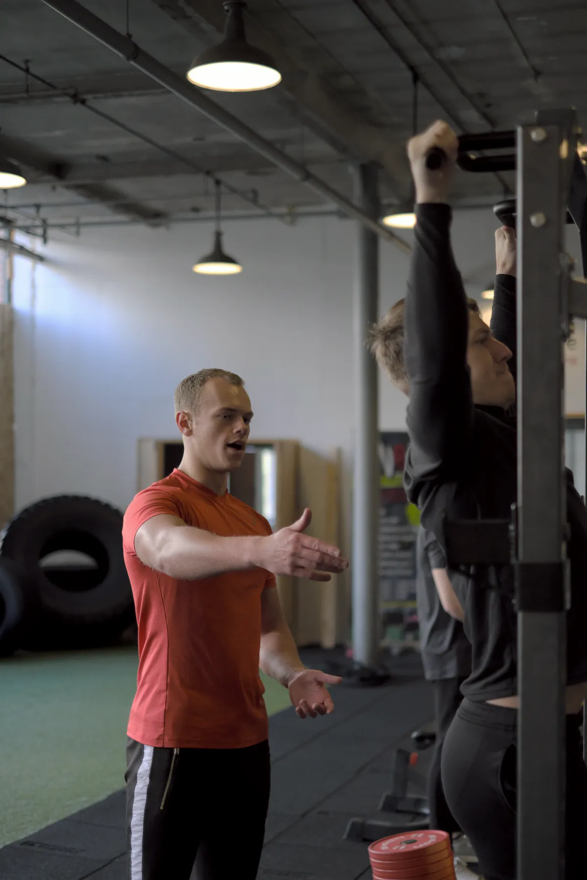 A tutor coaching a learner through a pull-up