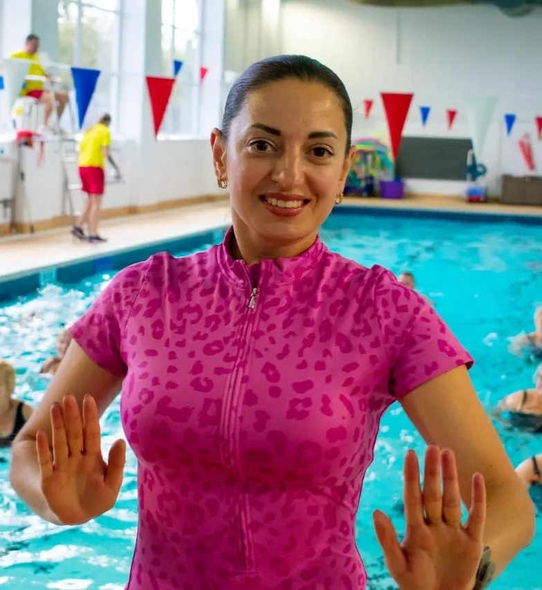 Vita Koval smiling beside a swimming pool