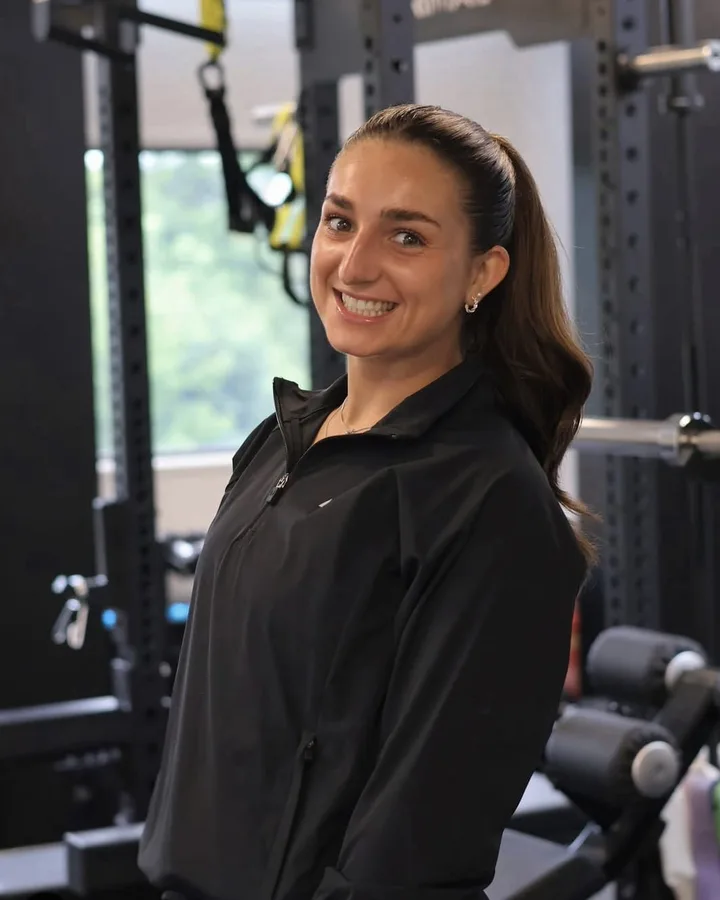 Emily Cross smiling in a gym