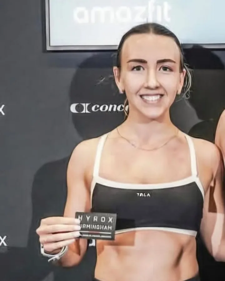 Georgia Long holding her HYROX Birmingham finisher card