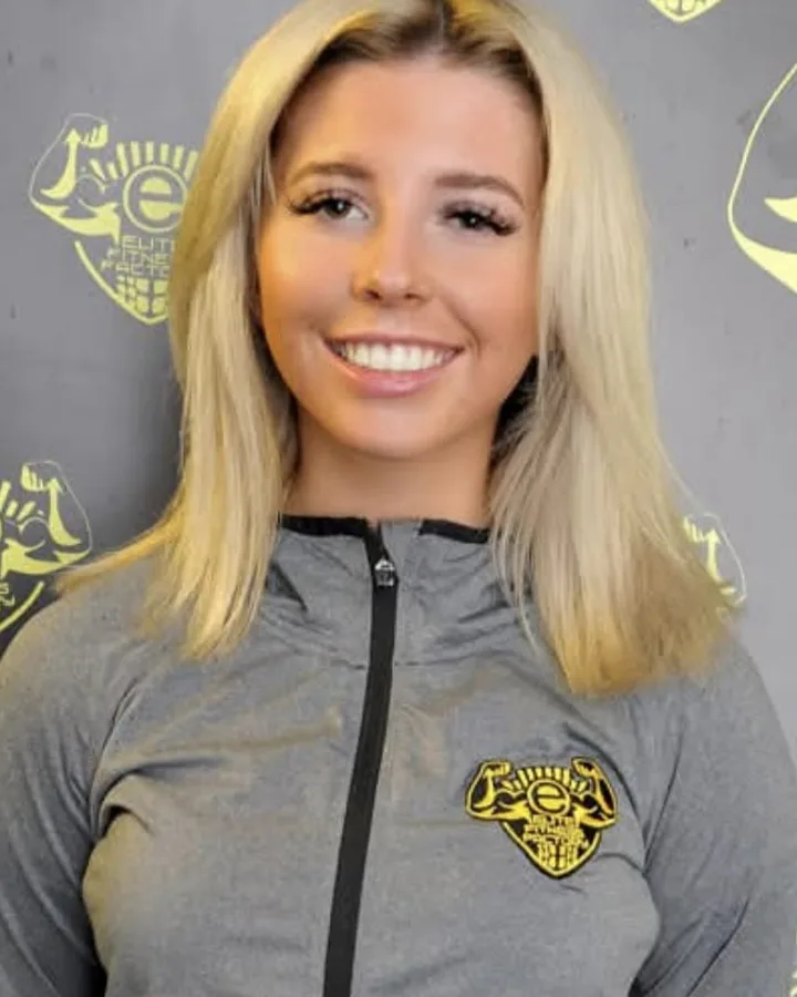 Millie Jones smiling in front of a gym backdrop