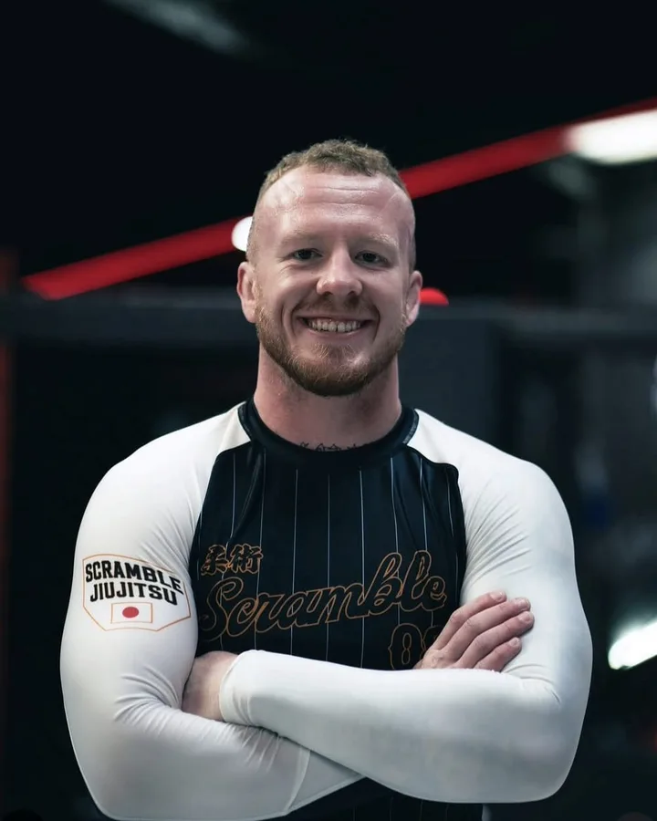 Zac Fagan, arms folded, in a jiu-jitsu gym