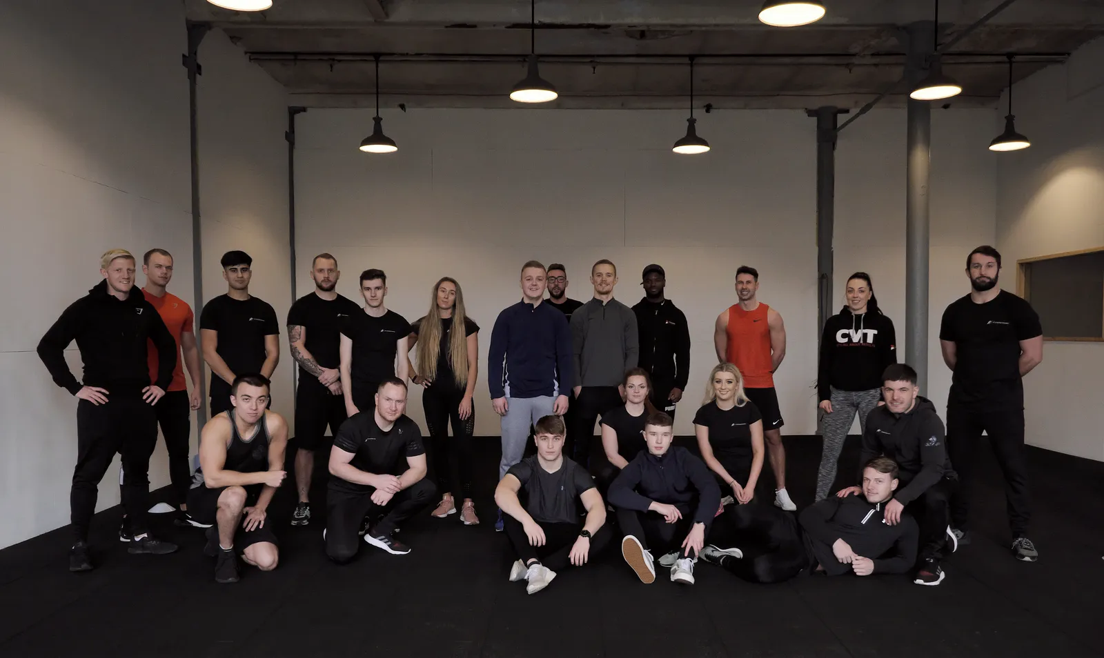 The PTNE learner cohort and tutor team together on the gym floor